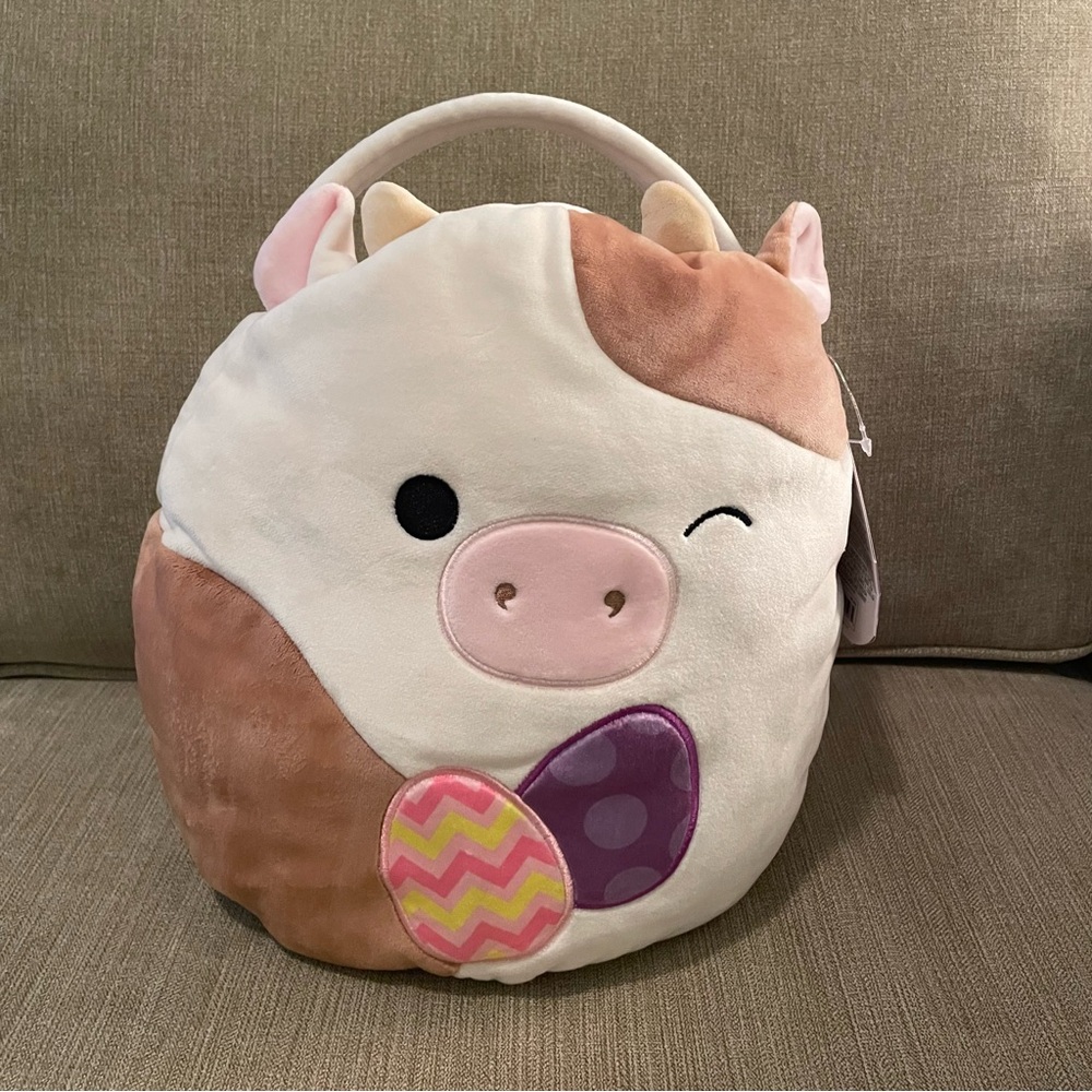 Squishmallows Ronnie the Cow Treat Pail with a Easter egg design on front